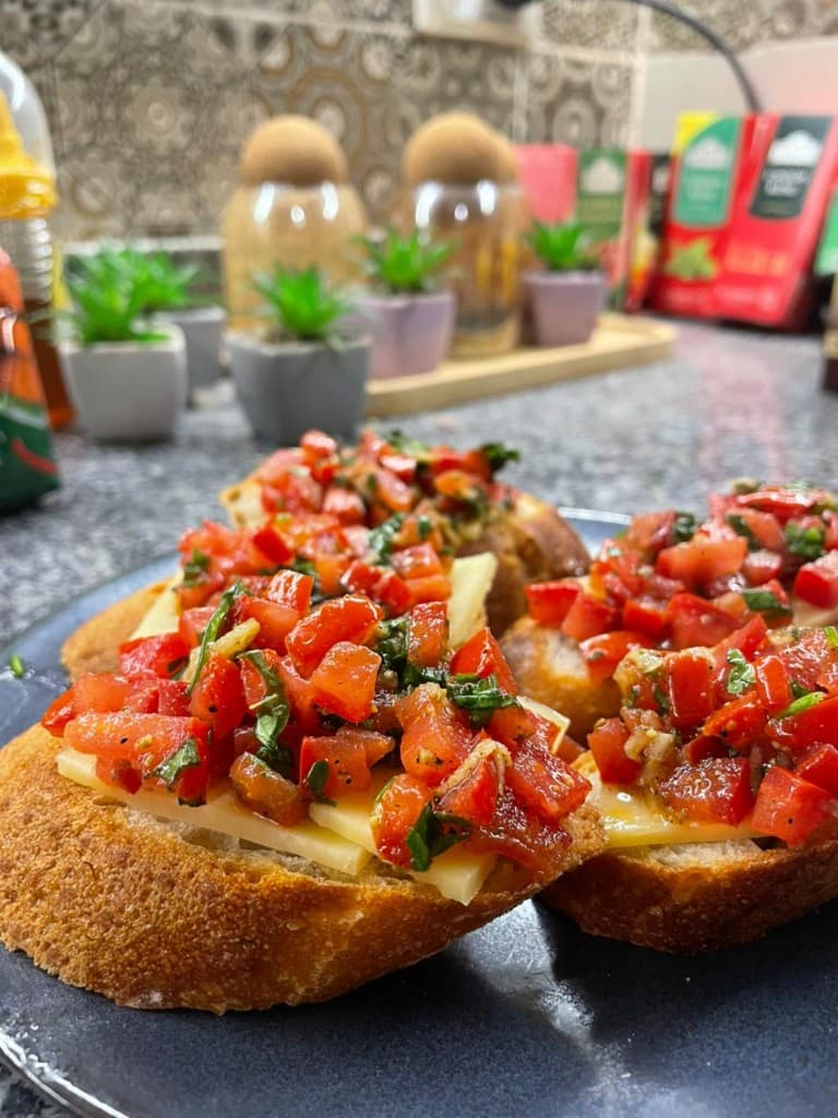 Bruschetta on toasted sourdough with cheese, tomato, and basil